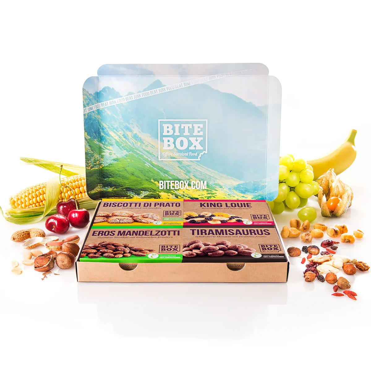 Bite Box Snackbox mit vier Sorten Nüsse, Trockenfrüchte, Kirschen, Trauben, Banane und Mais.