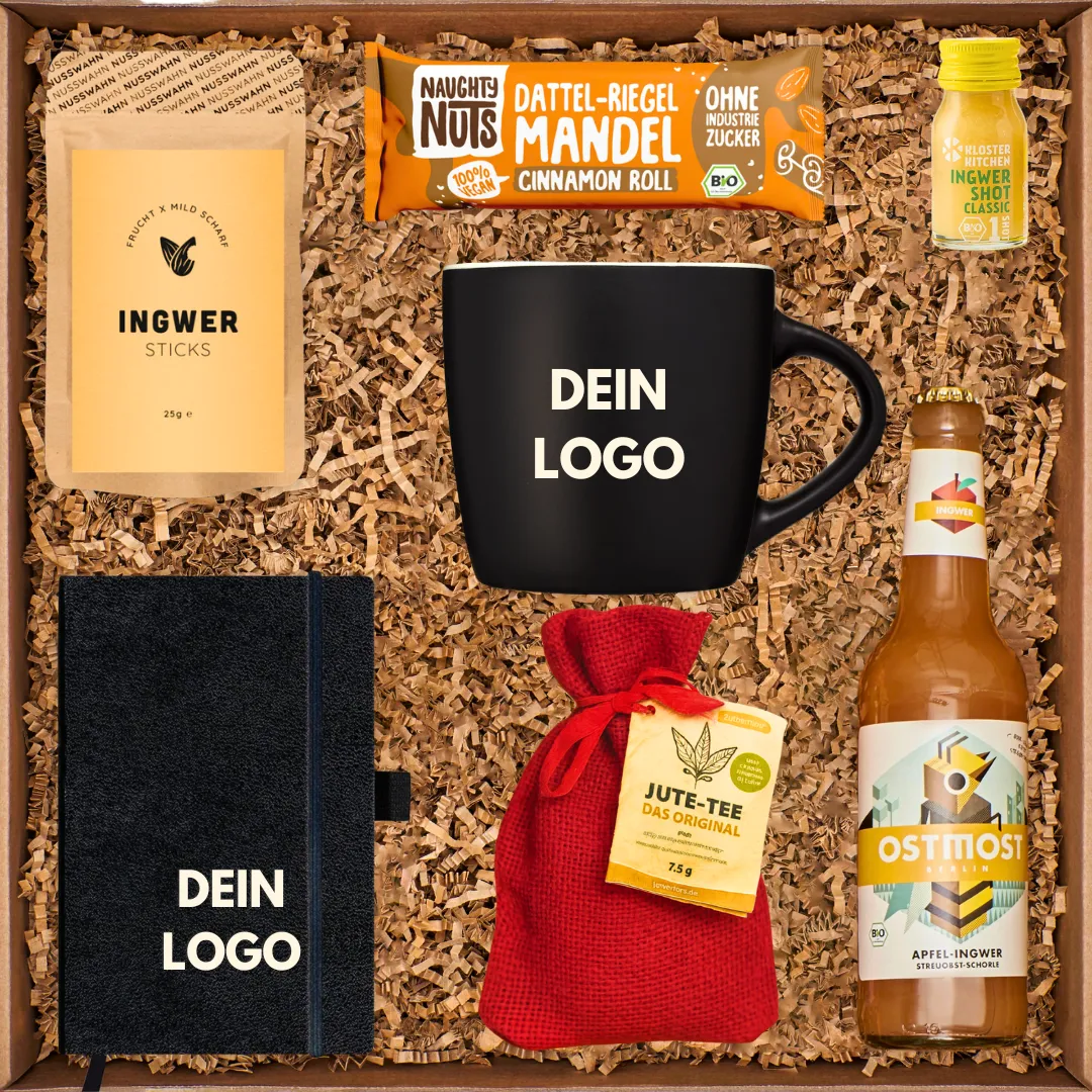 Geschenkbox mit Ingwersticks, Dattelriegel, Ingwershot, Tasse, Notizbuch, Jutetee und Apfel-Ingwer-Getränk.